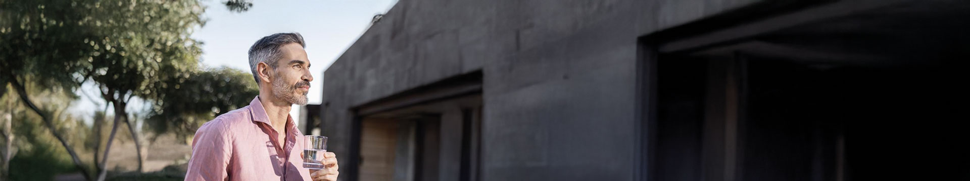 A man holding a glass of water