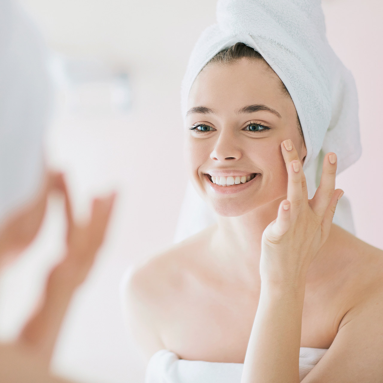 Frau bestaunt ihre schöne, seidenweiche Haut. Dank einer BWT Enthärtungsanlage.