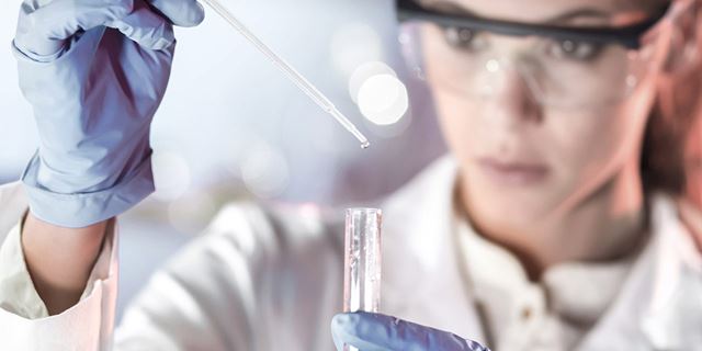 Female chemist analyzing purified water