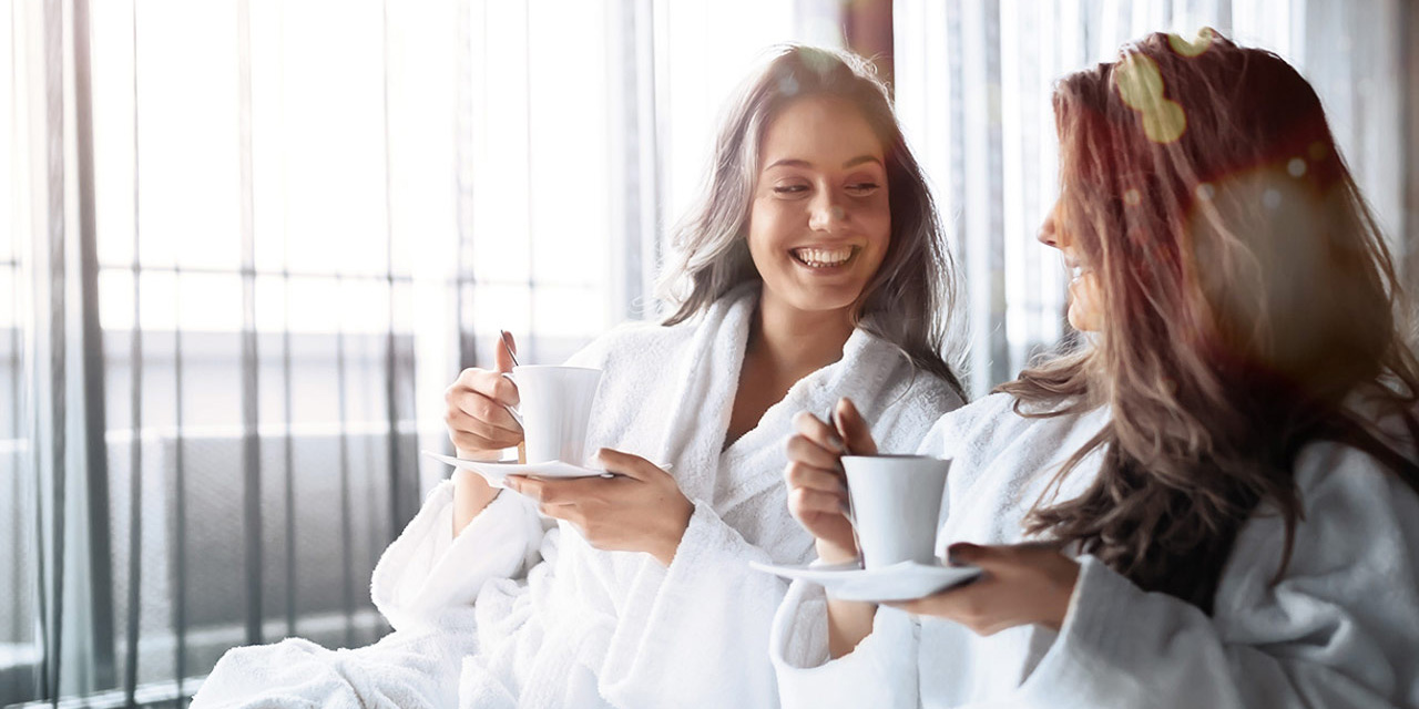 Two women enjoying a fresh cup of coffee