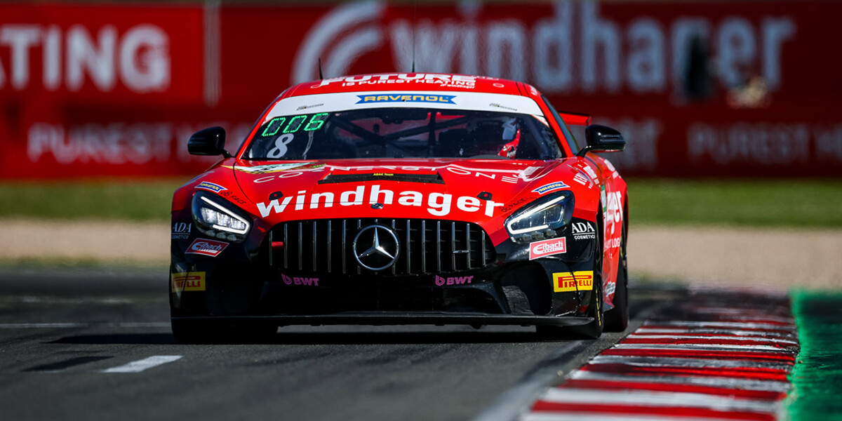 A dynamic view of a Windhager branded Mercedes-AMG GT3 race car in motion during a professional motorsport event.