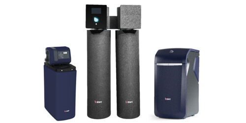 A selection of modern water softener units from BWT, featuring sleek, dark-toned designs. 